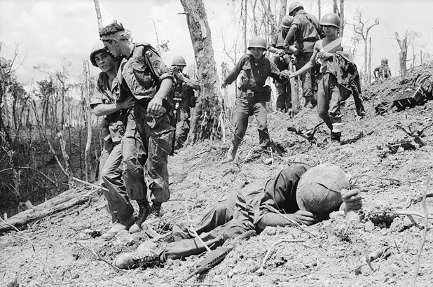 Figure 29. One wounded solder lies curled on the blasted slope. A soldier helps a wounded comrade down the hill. Behind them more wounded soldiers help each other down.