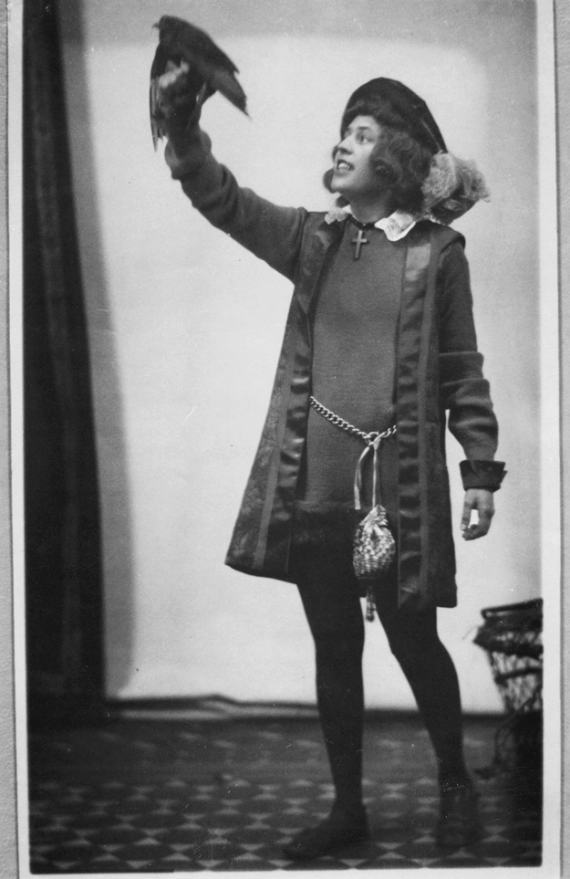 Figure 5. A young Heap is dressed in a masculine, Renaissance-style costume. She faces left, gazing cheerfully up towards a bird that she has perched on her raised hand.