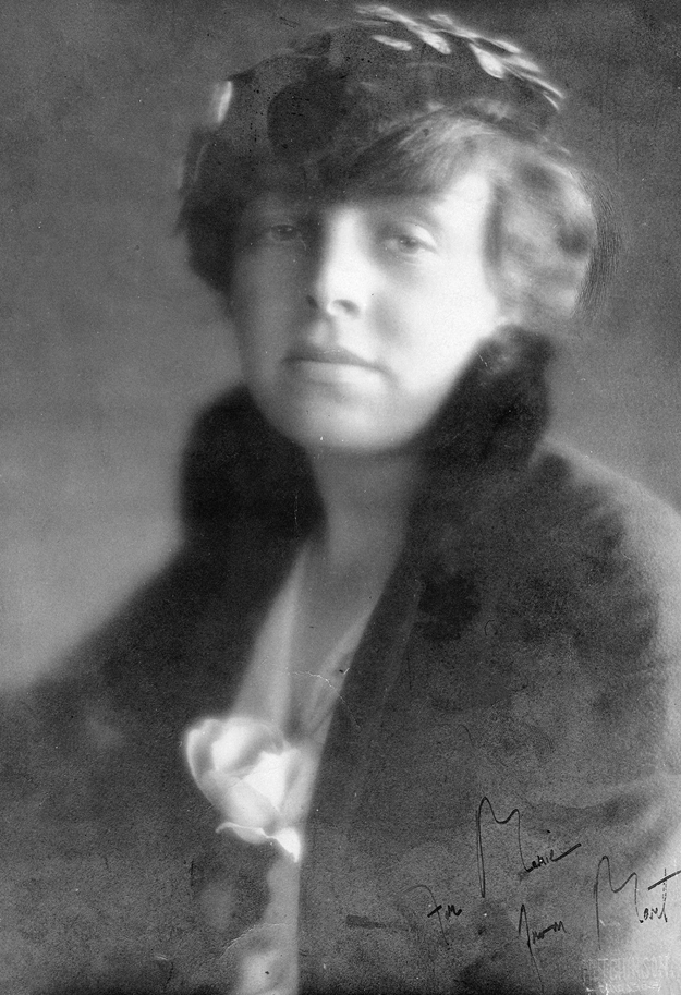 Figure 1. A young Margaret Anderson, her body turned away from the viewer, faces forward with a serious expression. She wears a heavy coat around her shoulders, and a half hat over her bobbed hair.