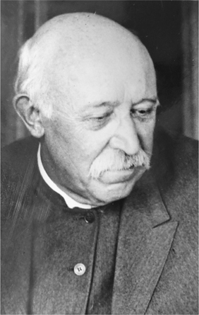 Figure 7.2. A balding, gray mustached man looks downward and appears dejected.