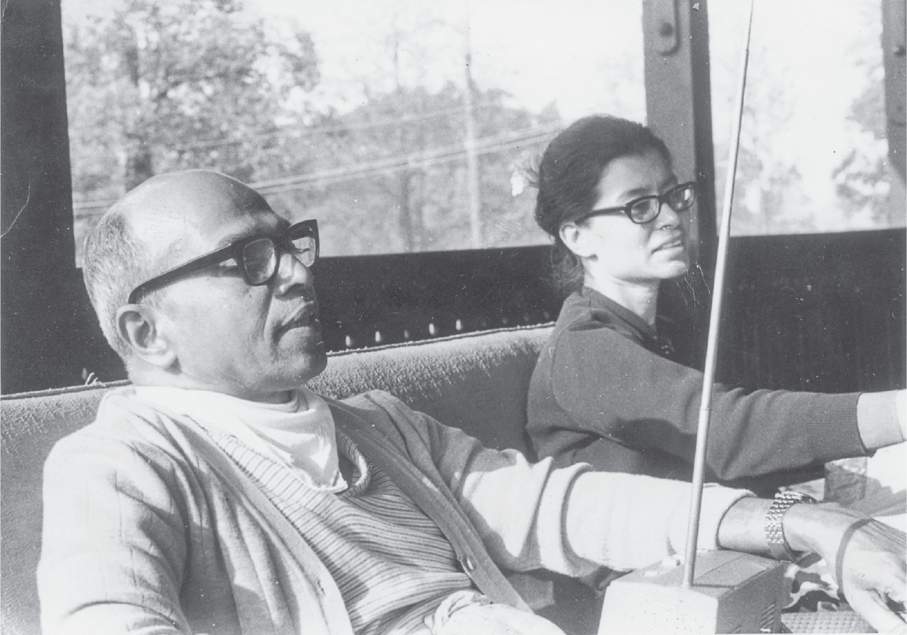 Uncle Mohan and Auntie Rosie, pregnant with their fourth child, sit beside one another and listen to the radio, always a favorite activity for the couple.