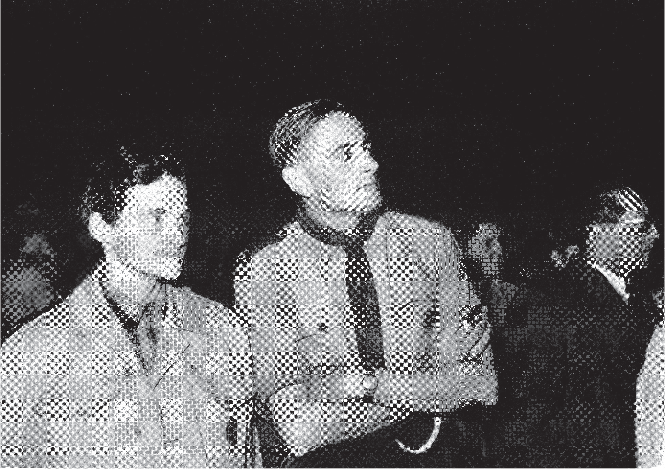 Two young men stand together at the European Youth Congress in The Hague in spring 1953. The young man on the right is wearing a scout uniform.