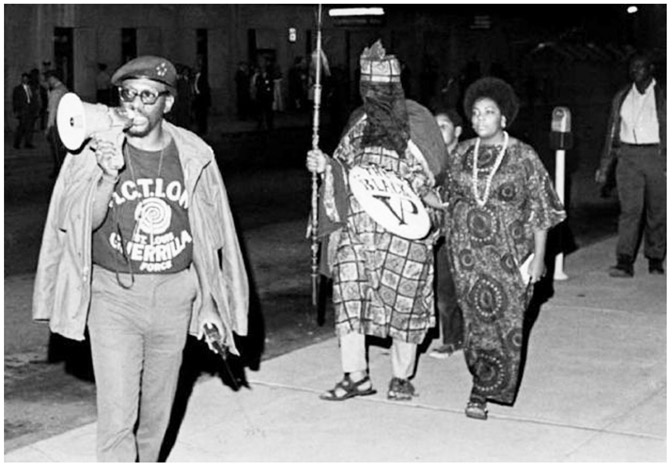 FIGURE 2.5 “Percy Green of ACTION (Action Council to Improve Opportunities for Negroes) heralds the arrival on Oct. 3, 1969, of the ‘black veiled prophet’ and his queen at Kiel Auditorium, where the annual Veiled Prophet Ball was taking place inside. ACTION frequently picketed the Veiled Prophet organization as racially exclusive and elitist. In 1972 in the same building, it engineered an unmasking of the man playing the role of the veiled prophet.” St. Louis Post-Dispatch, December 23, 2018. Photo by Gene Pospeshil, 1969.
