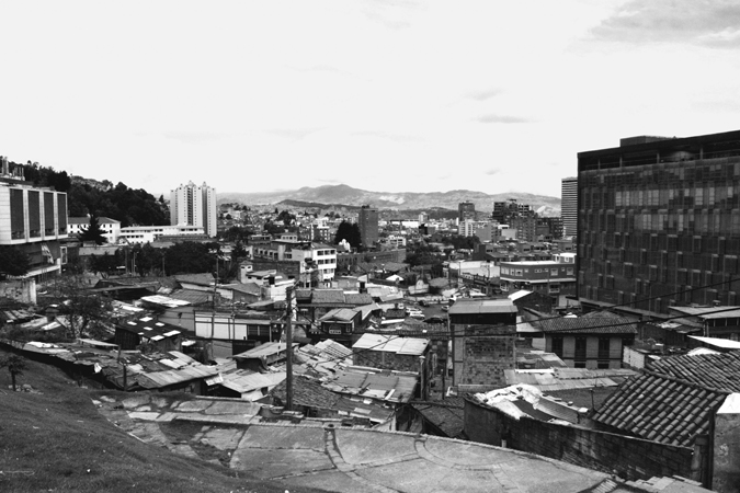 Figure 6.2. City buildings and rooftops, with a large, black building on the right side.