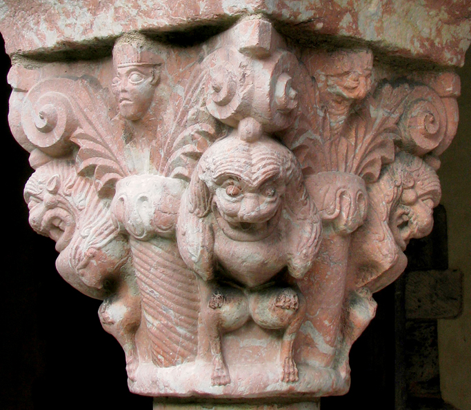 Figure 1. A capital of pink and white marble depicting grimacing lions standing on their hind legs carved in high relief on each corner. Above each lion’s head is a volute. Between the lions are columns from which sprout abstract palm fronds, between which are heads carved in relief.