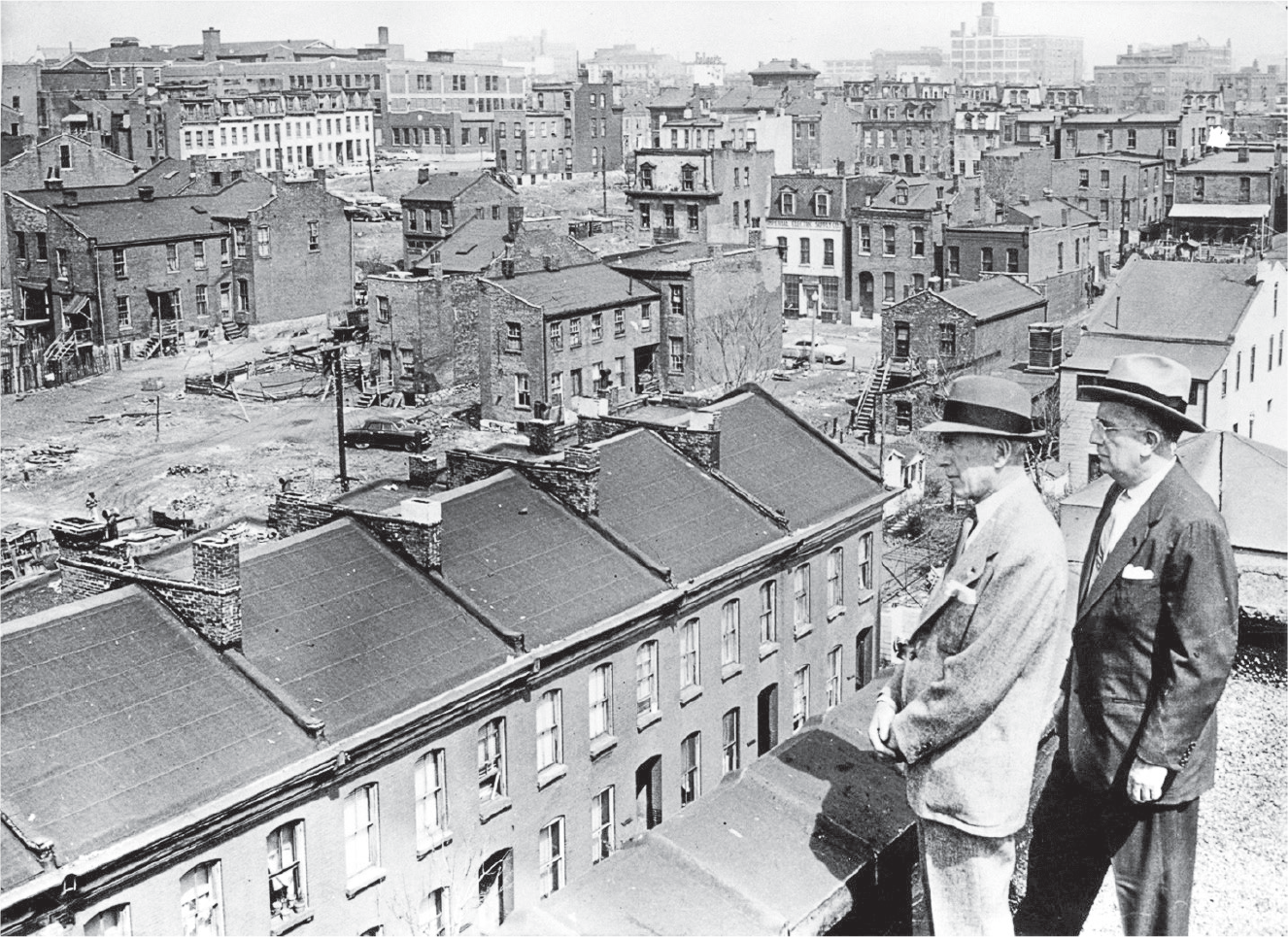 Figure 4.1: A 1956 photo of St. Louis mayor Raymond Tucker and civic leader and bond issue chairman Sidney Maestre looking out over Mill Creek Valley, a densely built up Black urban neighborhood slated for demolition.