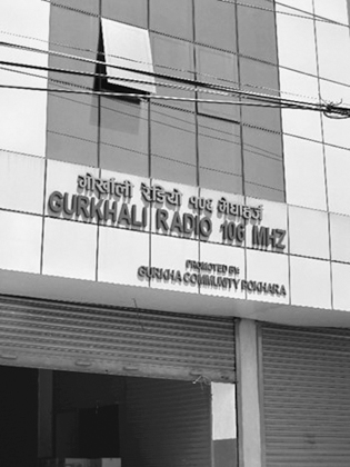 Figure 3.6. The outside of a radio station with signage that says Gurkhali Radio 106 MHZ.