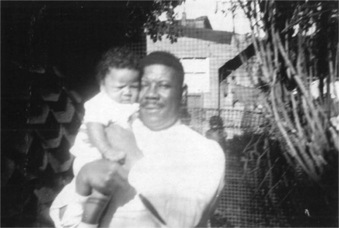 Figure 1 / Tom, age three months, with his father