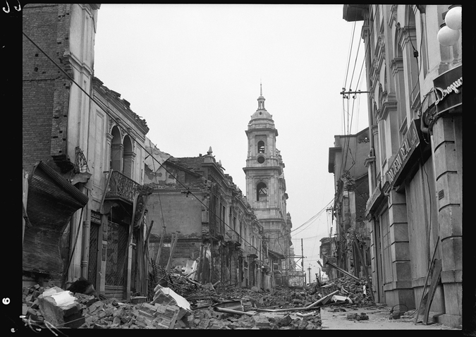 Figure 1.2. A street lined with the ruins of buildings and a large tower in the distance.