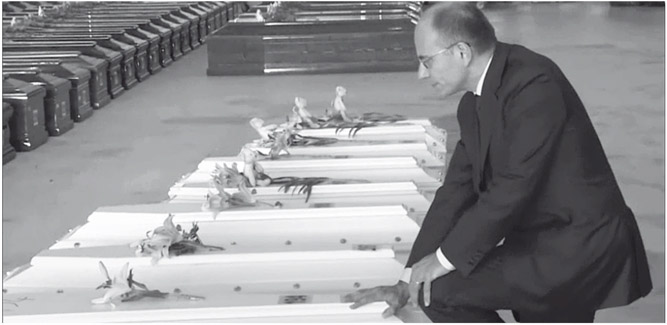 Figure 2. A man in a suit kneels in front of a row of children’s coffins and touches one with the number 194 on it.