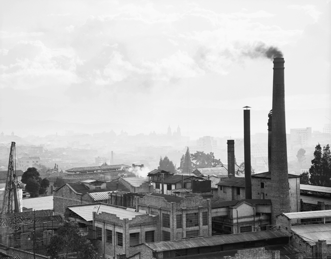 Figure 6.1. An urban skyline that includes a building with several large smokestacks on the right side of the frame.
