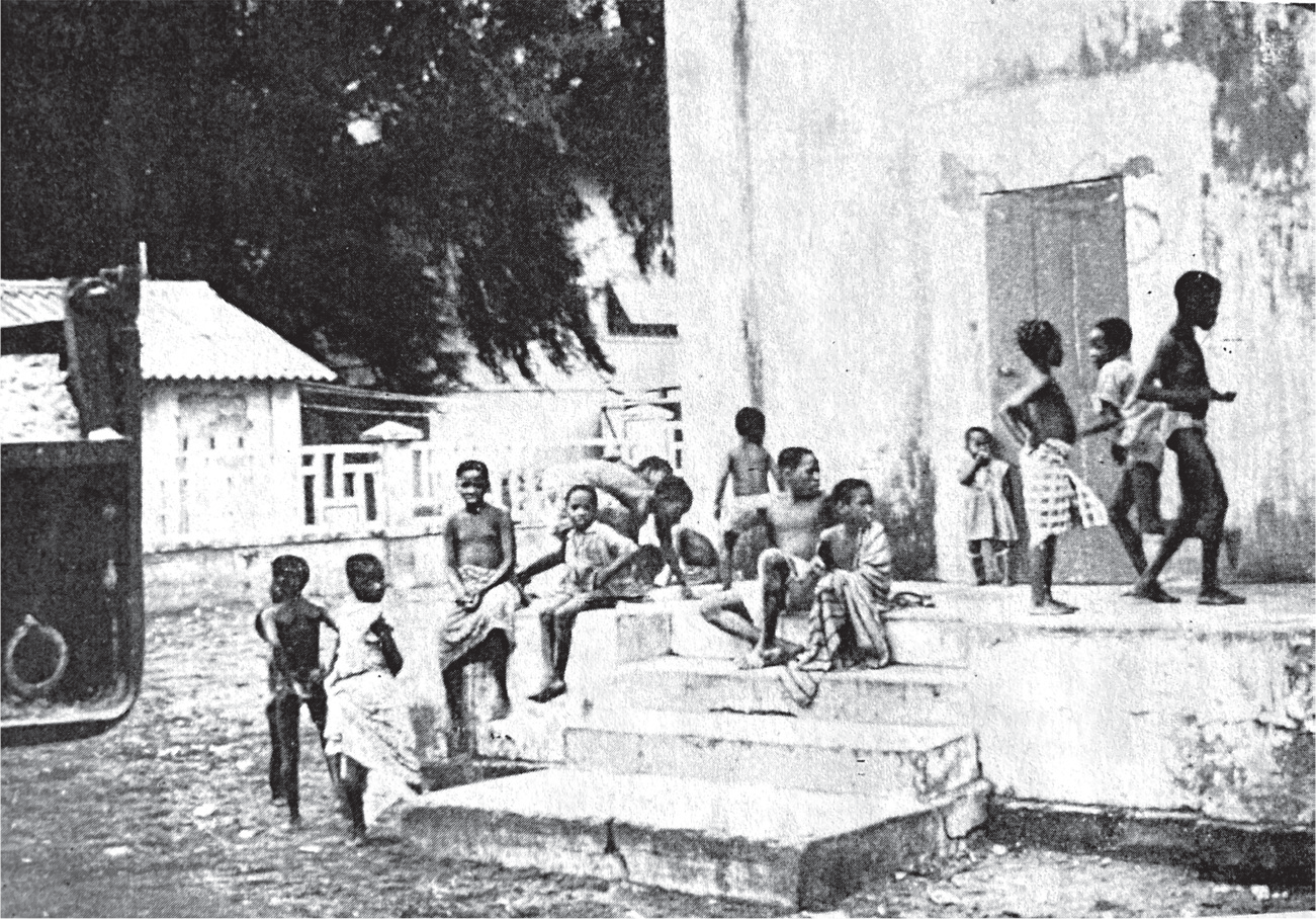 A group of school-age children gather on the streets of Saint Louis, Senegal.