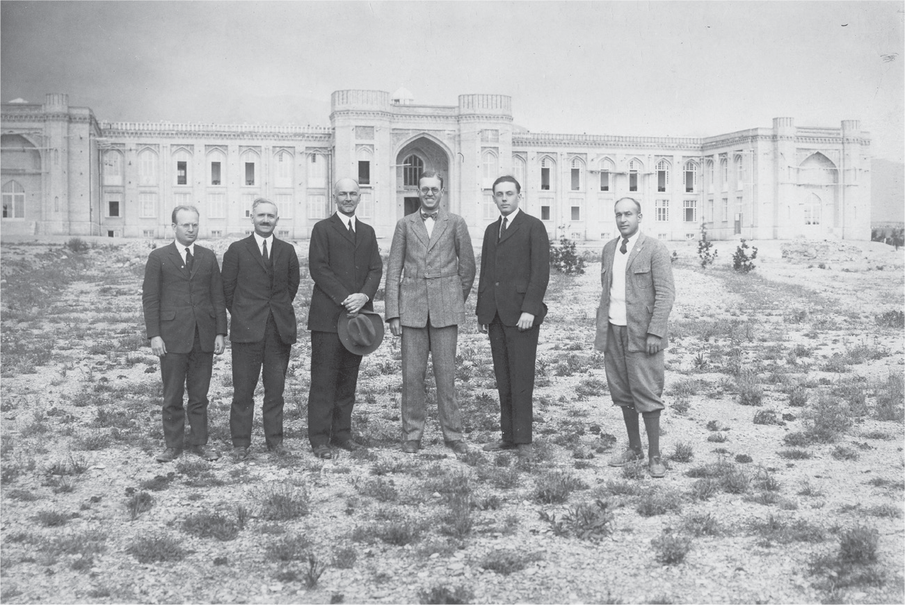 The Alborz College faculty—Walter Groves, Arthur Boyce, Samuel Martin Jordan, Herrick Young, Ralph Cooper Hutchison, and unidentified man—pose for a picture in front of Rollestone Hall in the late 1920s or early 1930s. While the building had Persian architectural characteristics, the campus resembled a scene out of the American West.