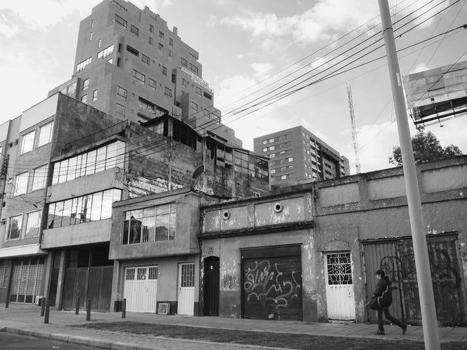 Figure 5.3. A street view, with a large building with a cake-like architectural structure in the background, and smaller rectangular buildings in the foreground.