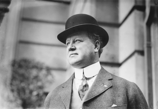 Figure 7.3. A well-dressed man with a high celluloid collar, tie and lapel pins, and a bowler hat looks past the camera with a confident air.