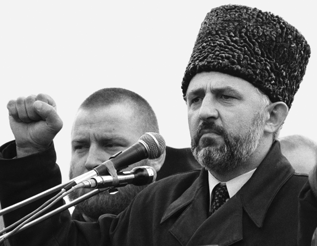 Chechen president Aslan Maskhadov speaking into a microphone, undated.