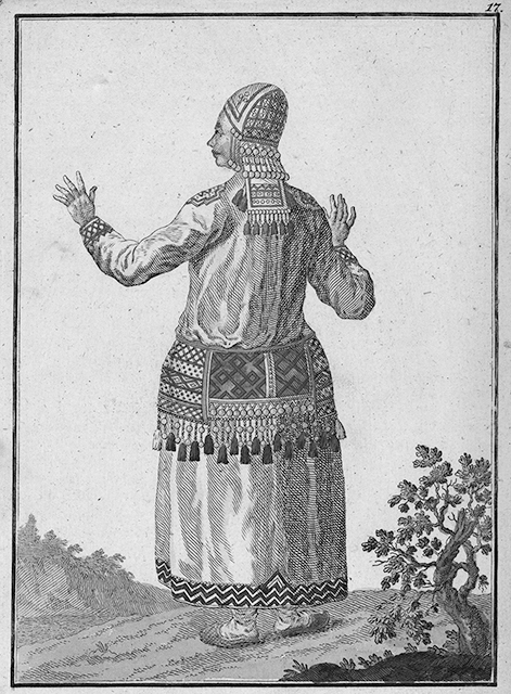 Figure 5.1. A Mordvin woman shown in traditional clothing, including a white dress and an embroidered large red belt and other red accents on the arms, shoulders, and headdress.
