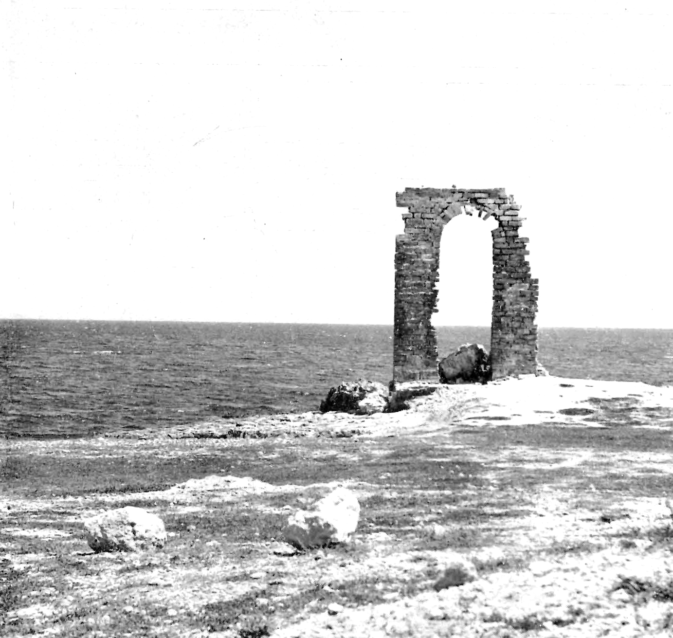 Figure 5: A crumbling stone archway sits on a coastal peninsula with the Mediterranean Sea in the background. According to Alexandre Lézine, this structure was constructed by the Normans during their occupation of Mahdia.