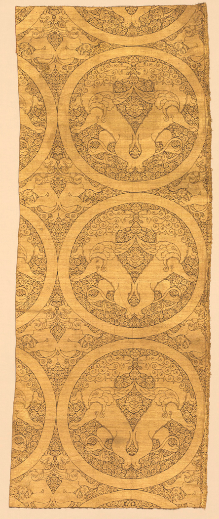 Figure 20. A strip of gold cloth with a repeating circular motif of two lions facing each other.