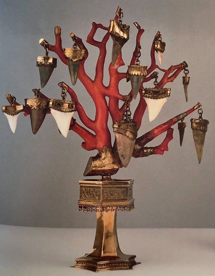 Figure 23. A piece of red coral mounted on a brass stand with tooth-shaped ornamental pieces, possibly sharks’ teeth, hanging from the upright branches.
