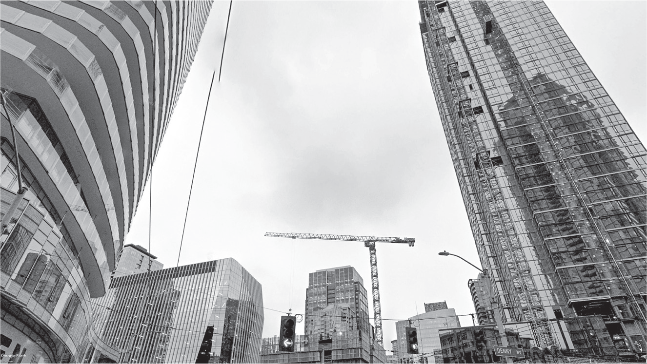 Figure 5.2: A photograph of construction cranes and glossy high-rise towers, a typical scene in downtown Seattle in the 2010s.