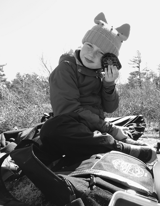 Jackie Litzgus’s seven-year-old daughter, looking very happy, holds a Spotted Turtle up to her face.
