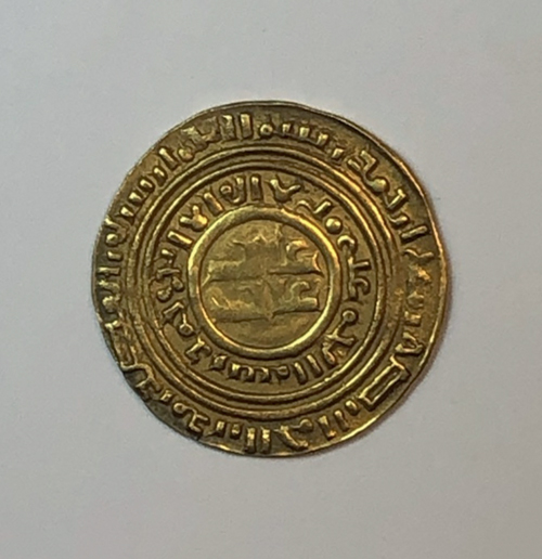 Figure 12.1. The obverse of a gold coin with a center image and two pseudo-Arabic inscriptions encircling the coin’s center and edge.
