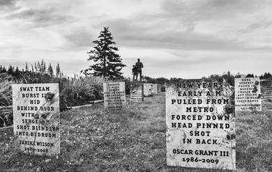 In the lawn around John Brown’s statue, lines of posters made to look like gravestones identify Black Americans killed unlawfully by law enforcement officers and vigilantes in the last century.