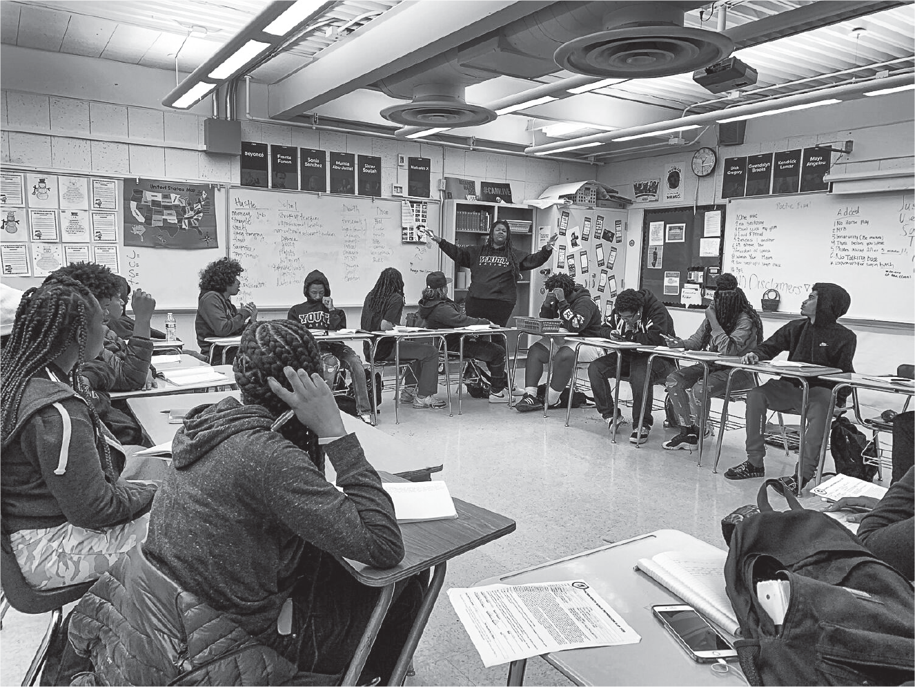 Figure 5.1. Students sit at desks in a circle facing each other in a classroom.