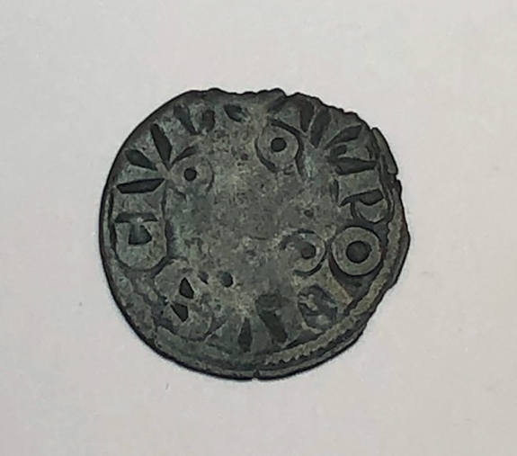 Figure 9.2. The reverse of a silver coin inscribed around the edges and very worn.