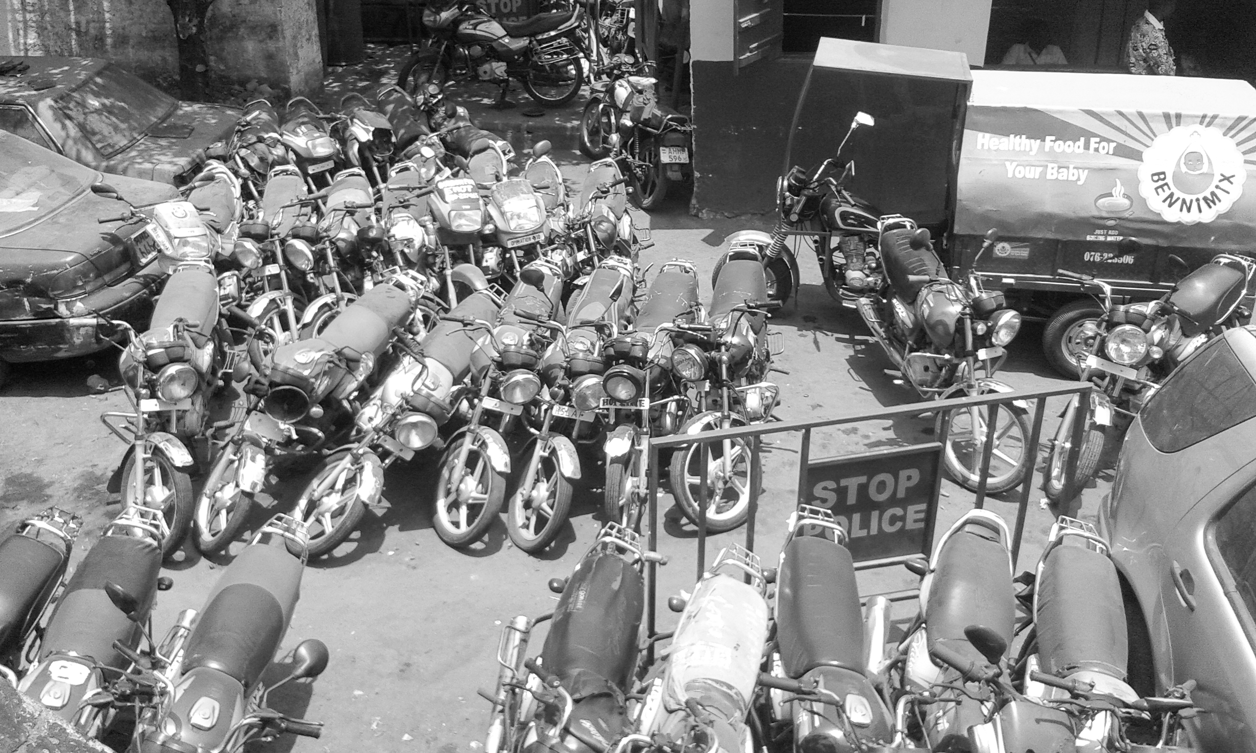 Figure 3. Several rows of parked motorbikes are lined up on a street.