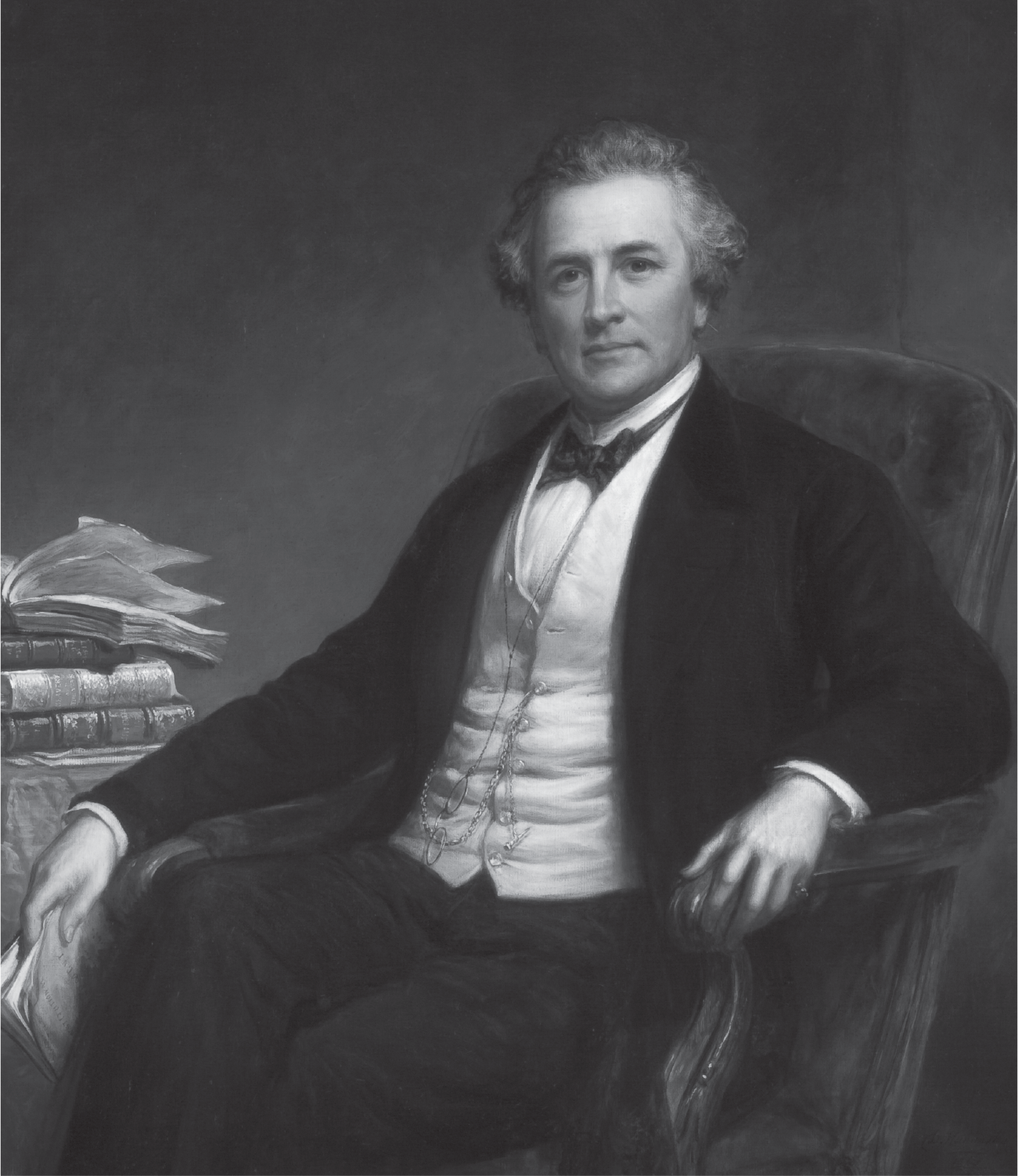 A man with graying hair is seated in a comfortable armchair, glasses and pocket watch fob dangling in front of his vest. His right hand, dropped to the side, holds a pamphlet. To his right is a stack of four books, the top one open face up.