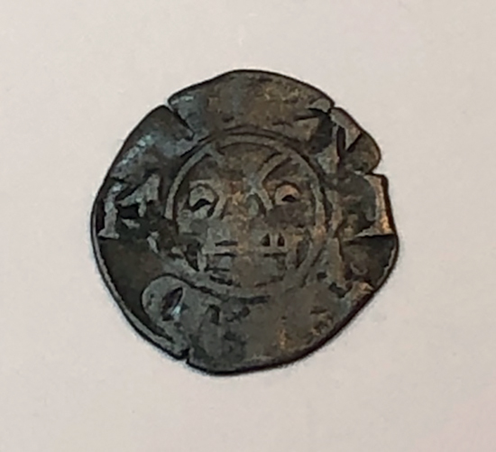 Figure 10.2. The reverse of a silver coin featuring a cross with two annulets.