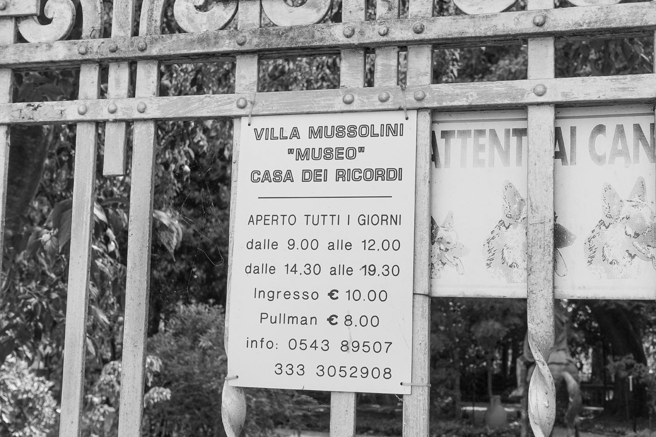 Figure 4.2. A sign attached to a metal gate gives the prices and opening hours of the Villa Mussolini. The sign says “‘Museo’ Casa Dei Ricordi,” which translates to “Museum, House of Memories.”