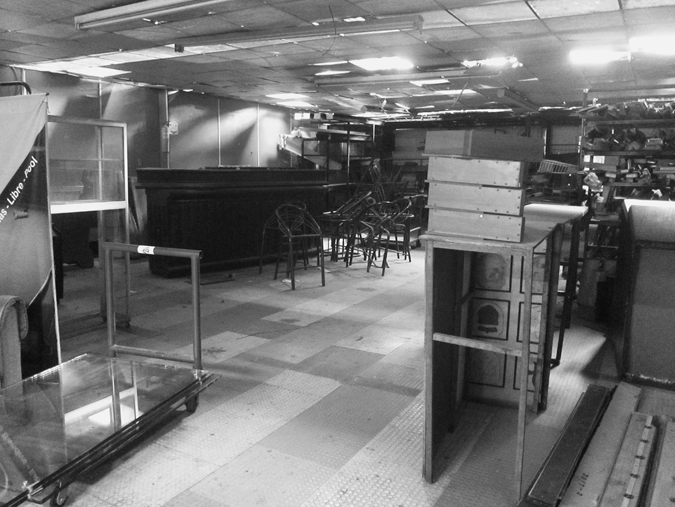 Figure 4.5. The inside of a billiard hall, with a bar in the background and scattered furniture waiting to be assembled.