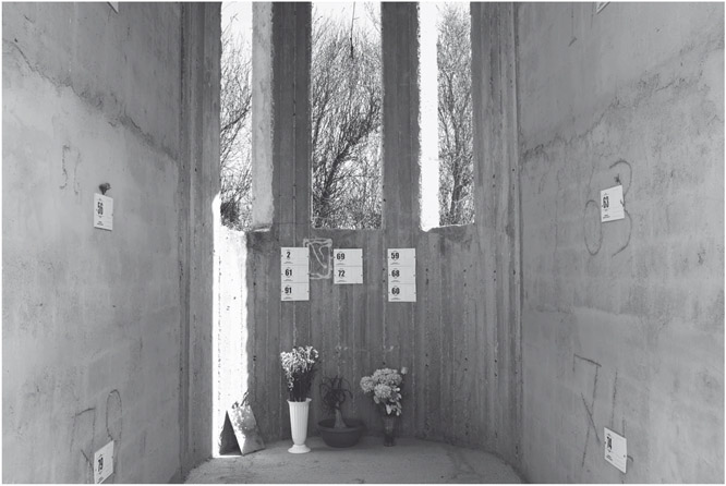 Figure 8. Numbered labels are attached to tall rough concrete walls with flower vases on the floor beneath them.