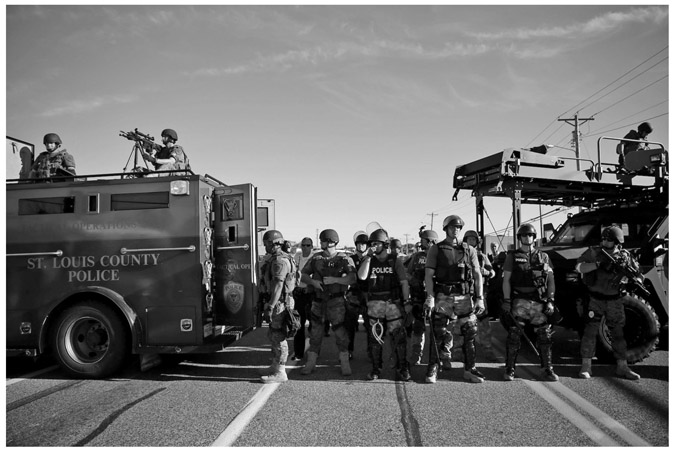 FIGURE A.3 “Police in riot gear watch protesters in Ferguson, Mo. on Wednesday, Aug. 13, 2014.”Associated Press. Photo by Jeff Roberson.