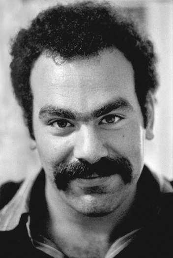 Figure 48. A dark-haired young man looks wryly into the camera. He has a handlebar mustache but no beard. His hair is relatively short for the time. He looks bemused.