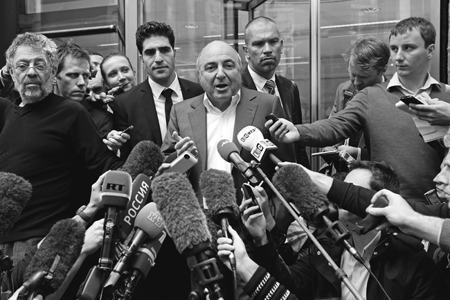 Berezovsky speaking to a crowd of reporters, who are holding microphones, with Alex Goldfarb standing to left, August 31, 2012.