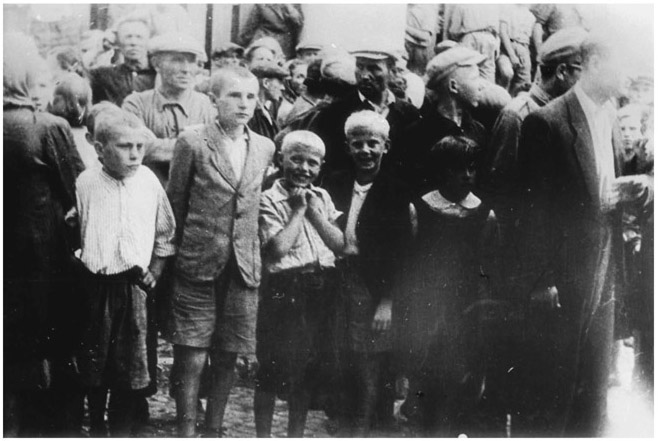 Figure 32. A group of children laughing together walking in a funeral procession.