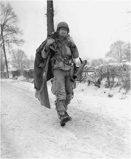 Figure 3. A soldier in gear walks along a snow-covered road.