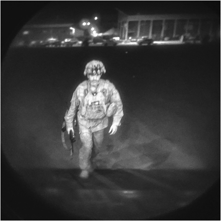 Figure 10. A soldier walks to board a cargo plane at night.