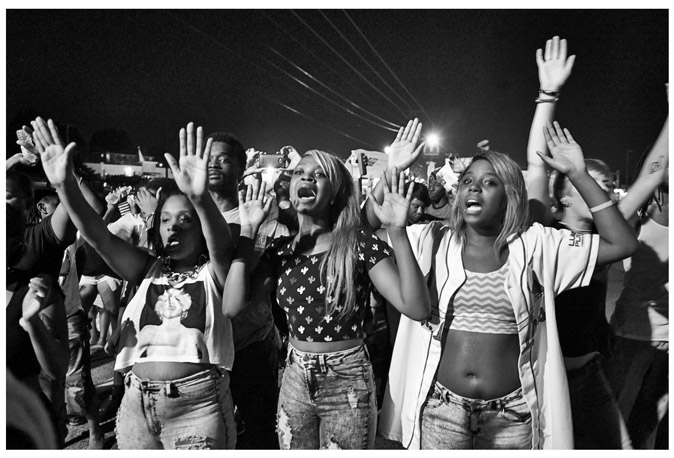 FIGURE 6.1 Three women protesting in Ferguson. “Officers in riot gear and wielding smoke bombs confronted protesters as scores of people defied the state-issued curfew in protest of Michael Brown’s death on Sunday, Aug. 17, 2014 in Ferguson, MO. The standoff came hours after Missouri Gov. Jay Nixon declared a state of emergency and announced the midnight curfew to quell rising unrest in the town.”New York Daily News. Photo by James Keivom.