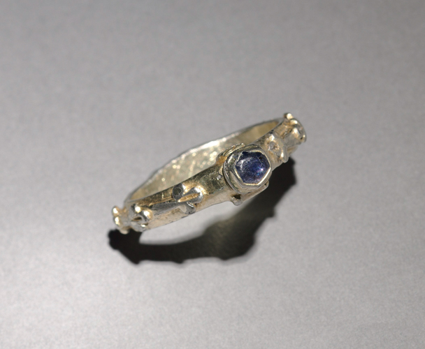Figure 17. A thin-banded silver ring with a small sapphire in a hexagonal setting.