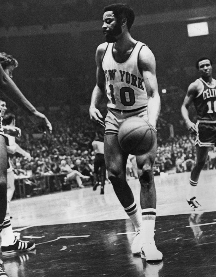 Walt Frazier dribbles the ball against the Boston Celtics.